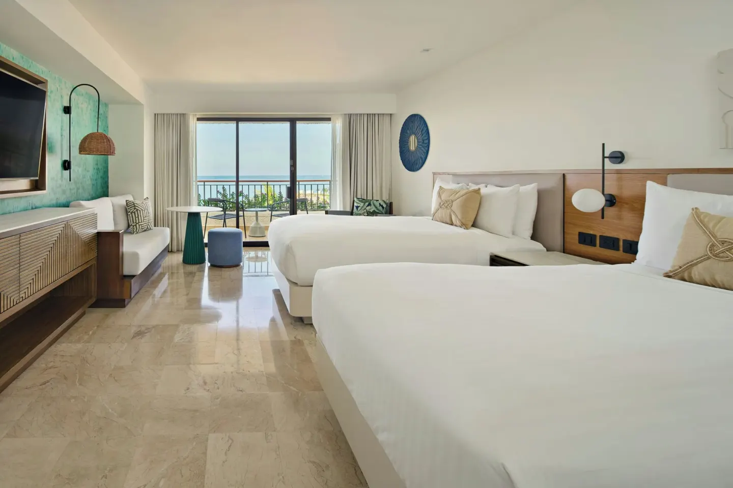 Guest room with two beds and balcony ocean view at Marriott Puerto Vallarta Resort & Spa.