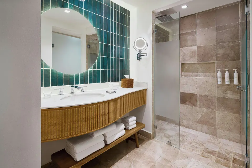 Guest room bathroom with vanity and glass shower at Marriott Puerto Vallarta Resort & Spa.