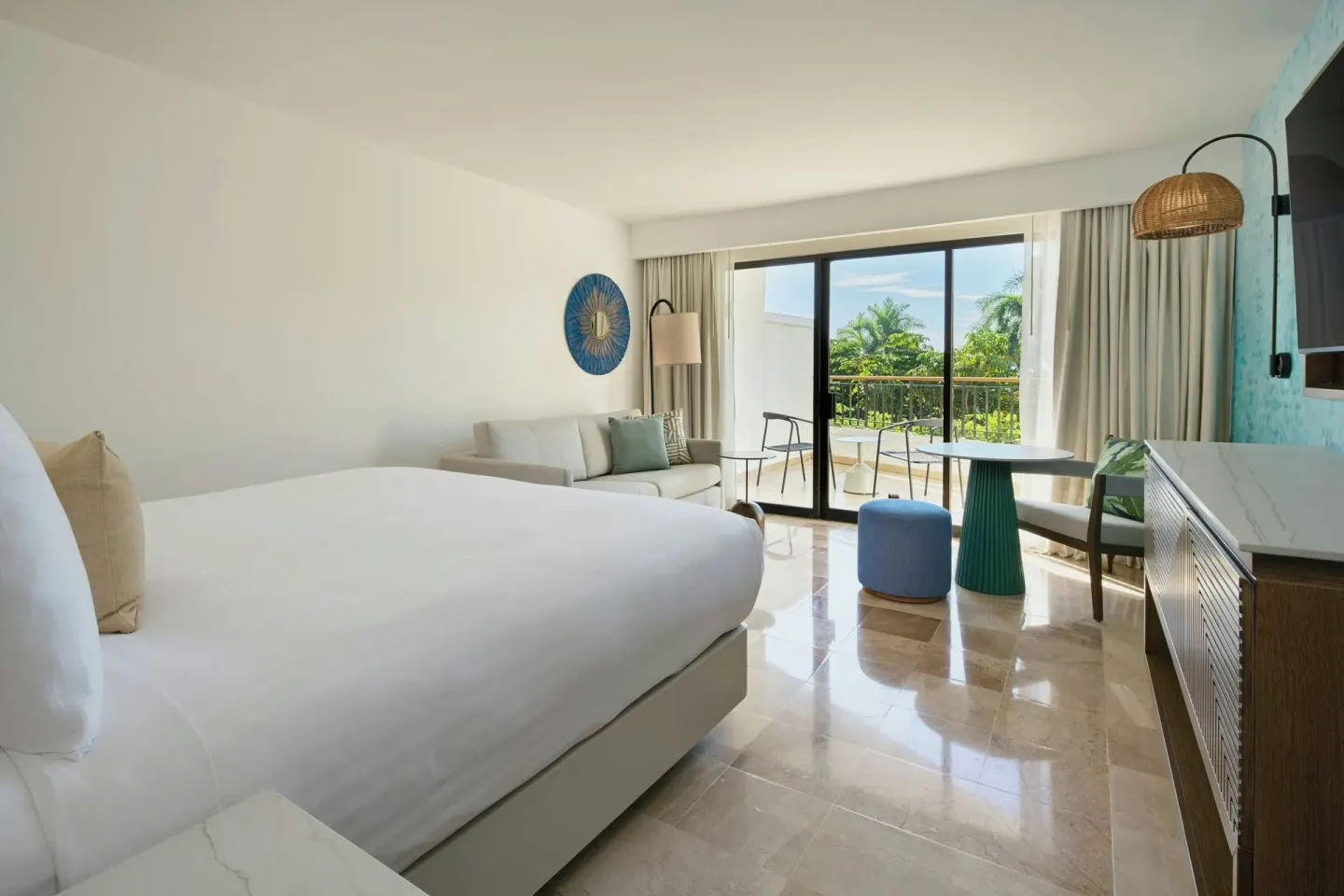 Room with sofa bed and garden-view balcony at Marriott Puerto Vallarta Resort & Spa.