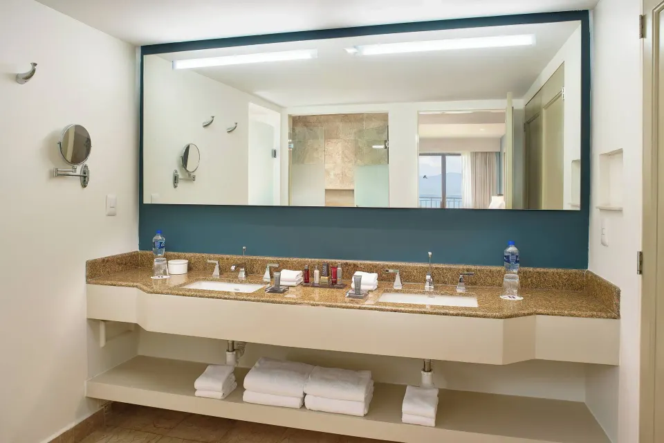 Oceanfront suite bathroom at Marriott Puerto Vallarta Resort & Spa with double sinks and large mirror.