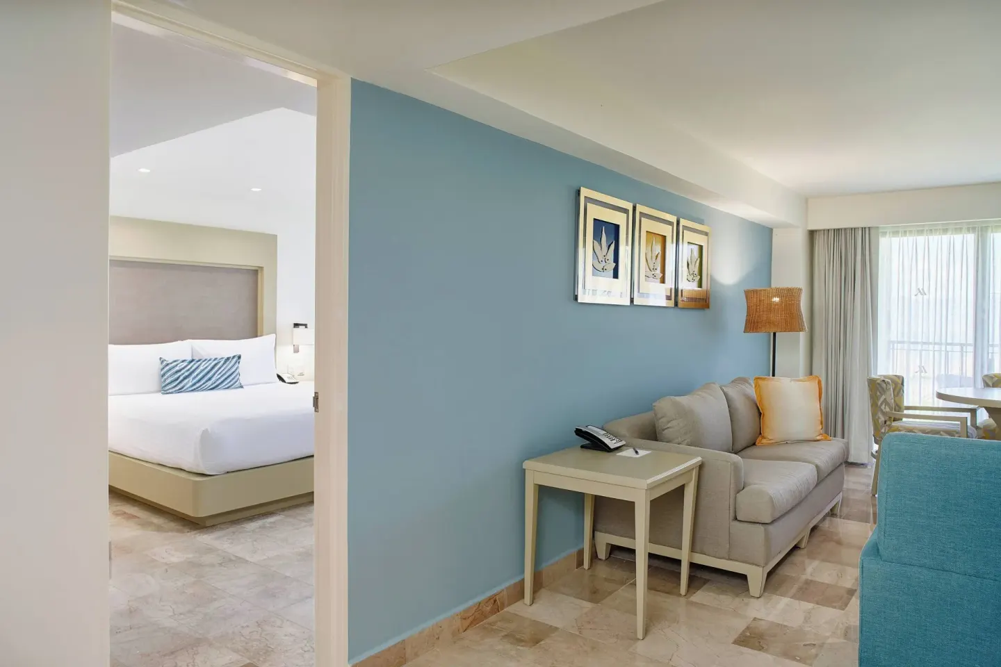 Oceanfront one-bedroom suite sitting area at Marriott Puerto Vallarta Resort & Spa with sofa and bedroom doorway.