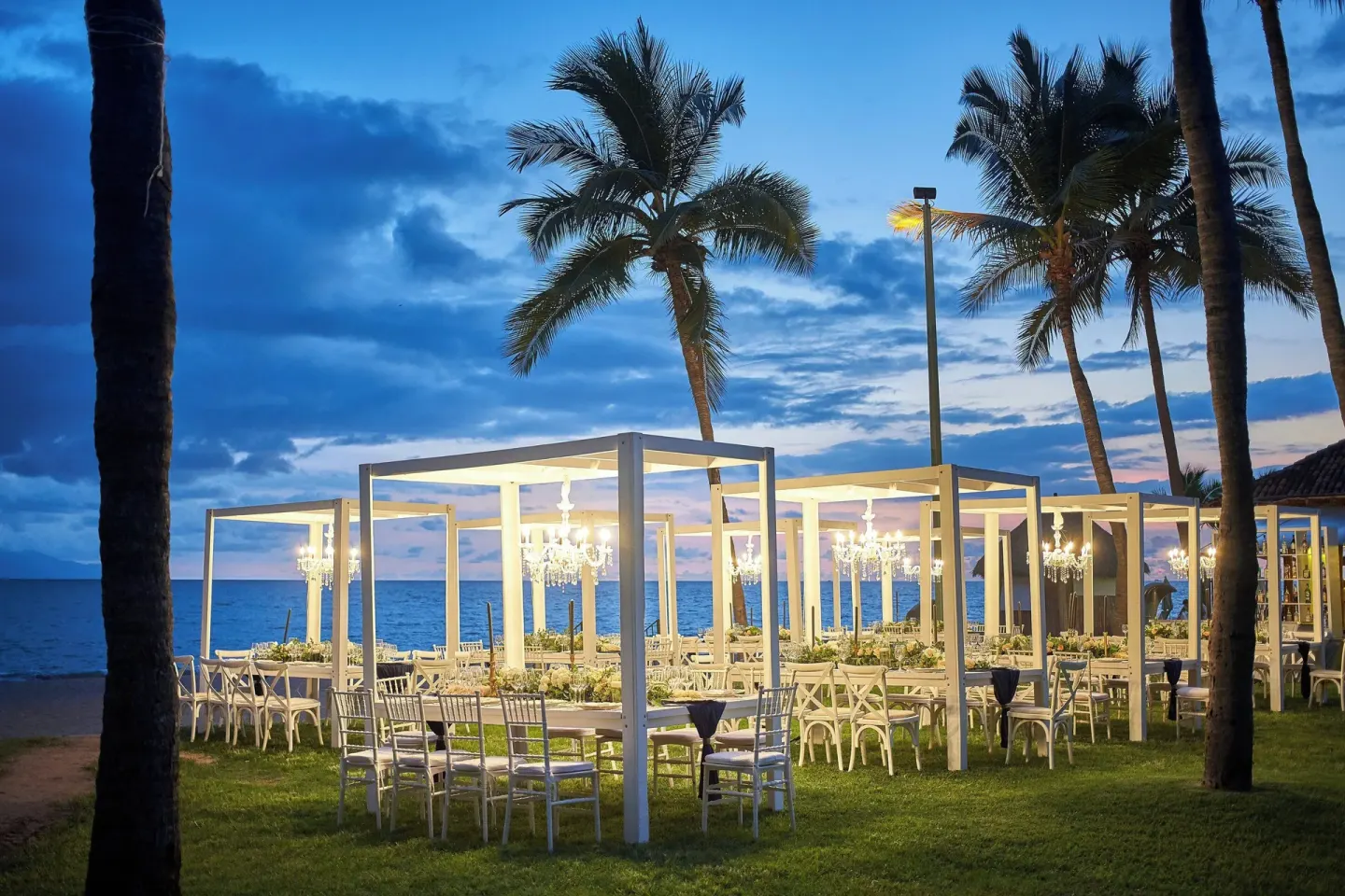 Outdoor beach event setup with chandeliers at Marriott Puerto Vallarta Resort & Spa.