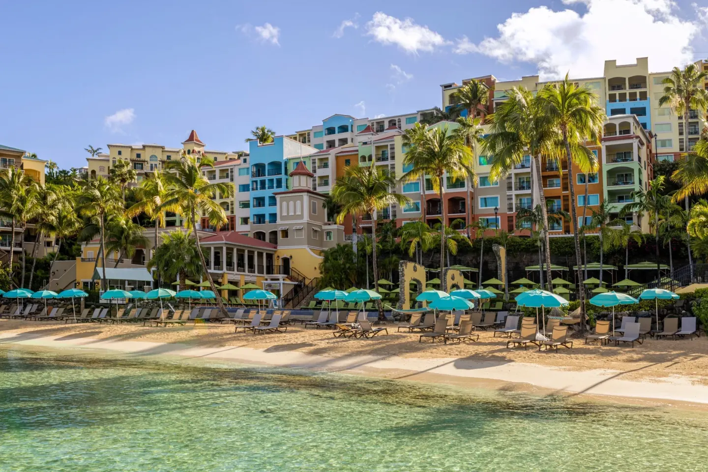 Beachfront resort buildings and lounge chairs at Marriott's Frenchman's Cove.