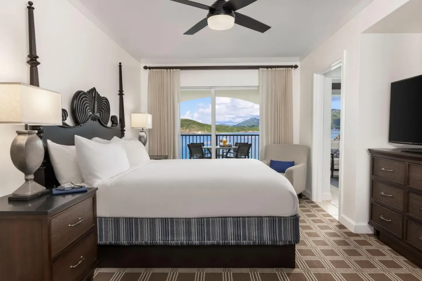 King bedroom with balcony and water view at Marriott's Frenchman's Cove.
