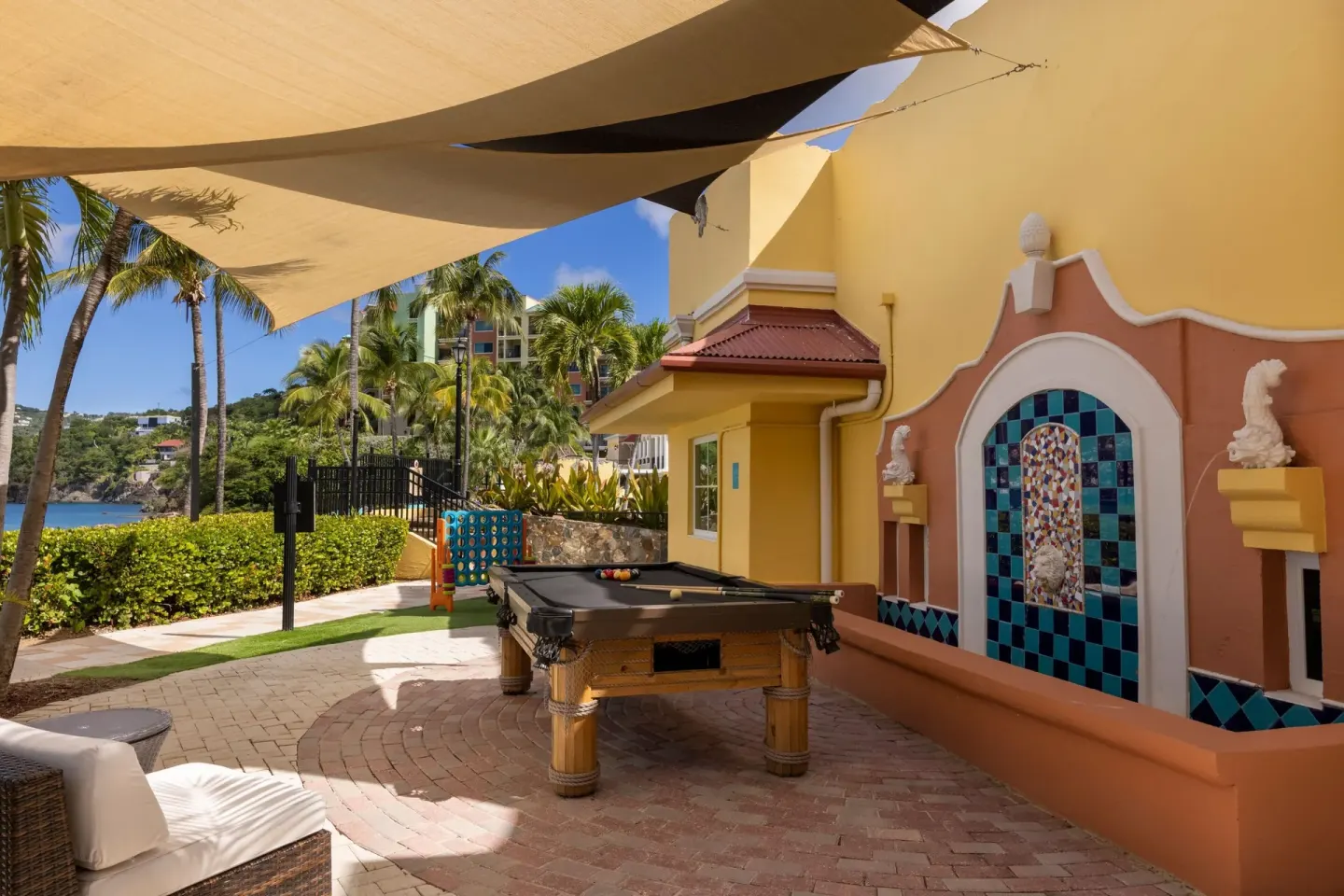 Shaded outdoor game patio with a pool table at Marriott's Frenchman's Cove.