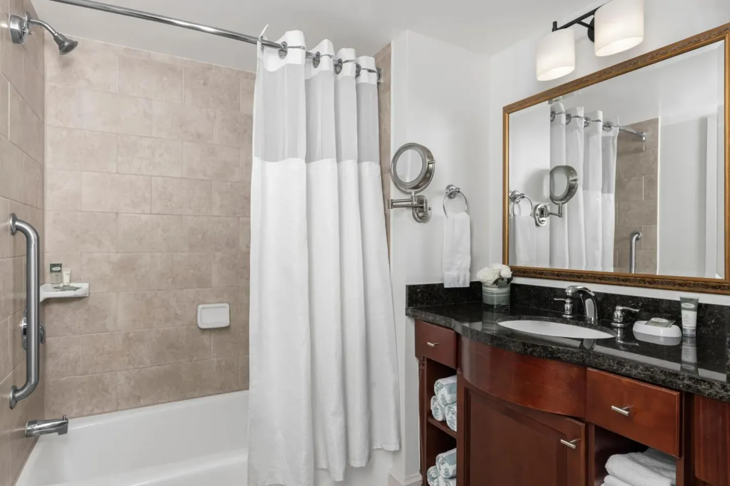 Bathroom with tub shower and vanity at Marriott's Frenchman's Cove.