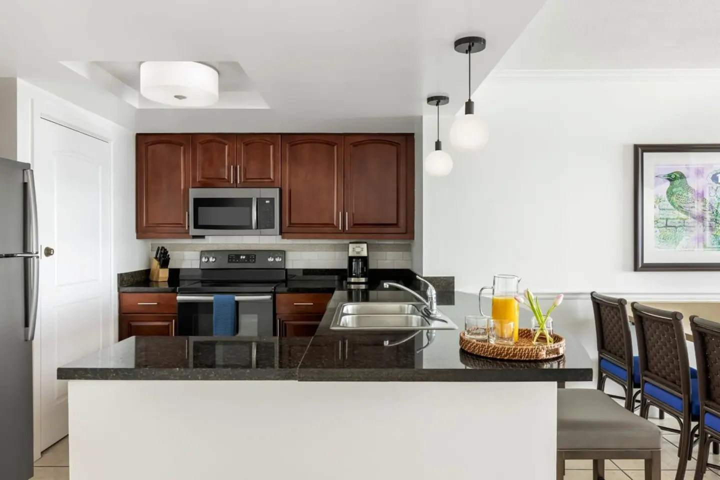 Villa kitchen with island, appliances, and dining chairs at Marriott's Frenchman's Cove.