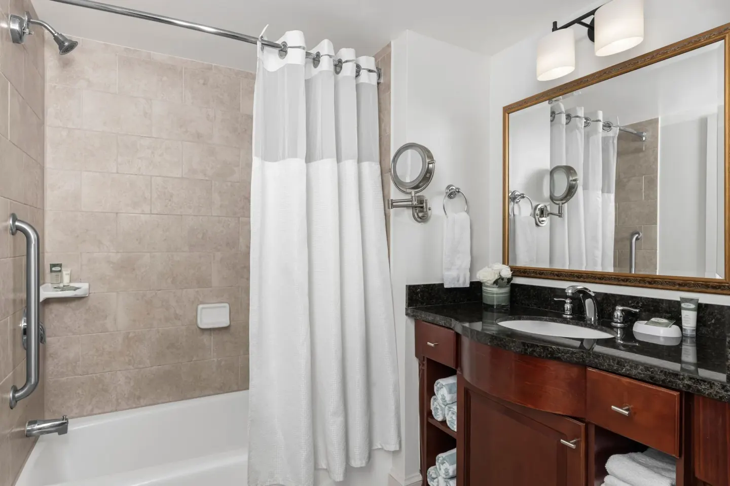Villa bathroom with tub, shower curtain and vanity at Marriott's Frenchman's Cove.