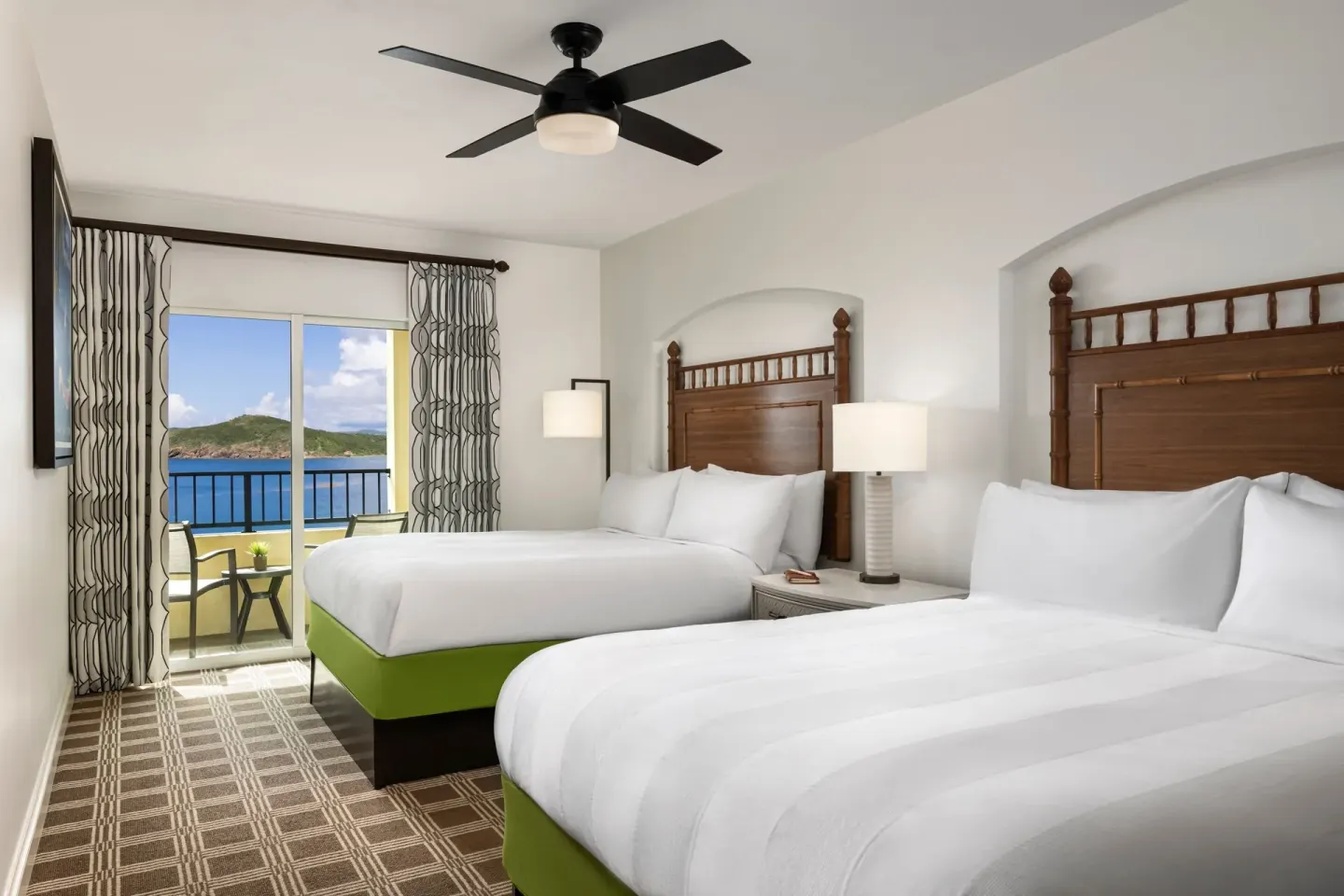 Two-bed villa bedroom with balcony and ocean view at Marriott's Frenchman's Cove.