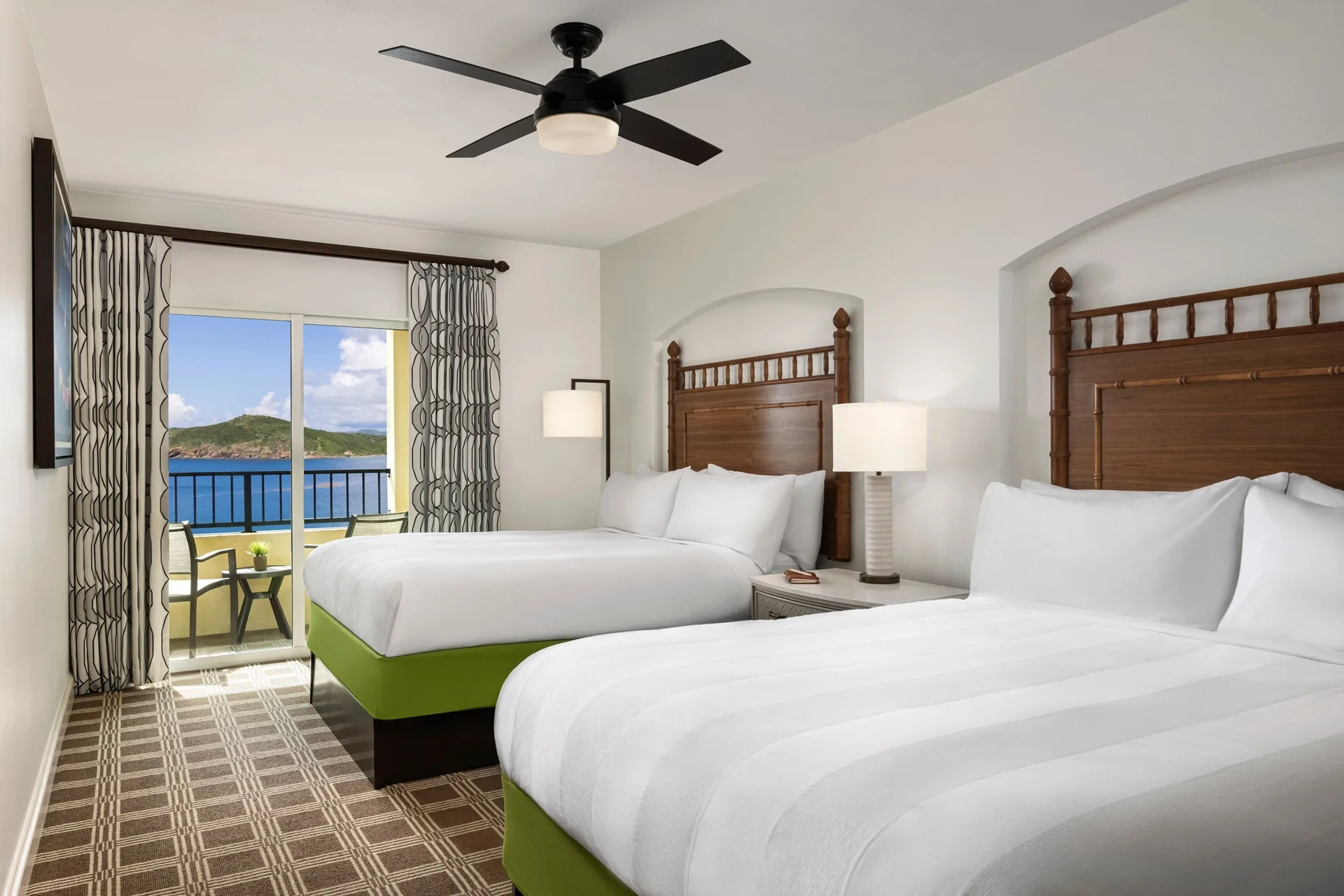 Two-bed villa bedroom with balcony and ocean view at Marriott's Frenchman's Cove.