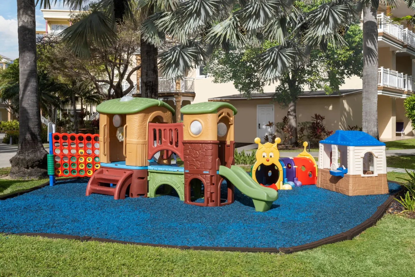 Children's playground with slides under palms at Marriott's St. Kitts Beach Club.