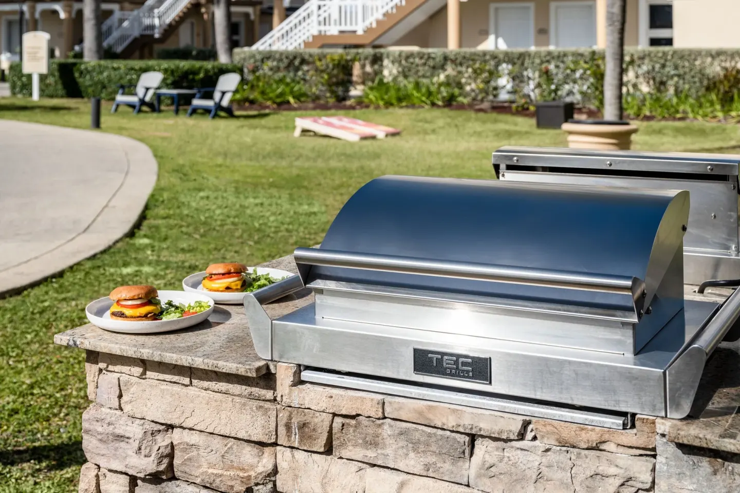Outdoor grill with plated burgers on the lawn at Marriott's St. Kitts Beach Club.