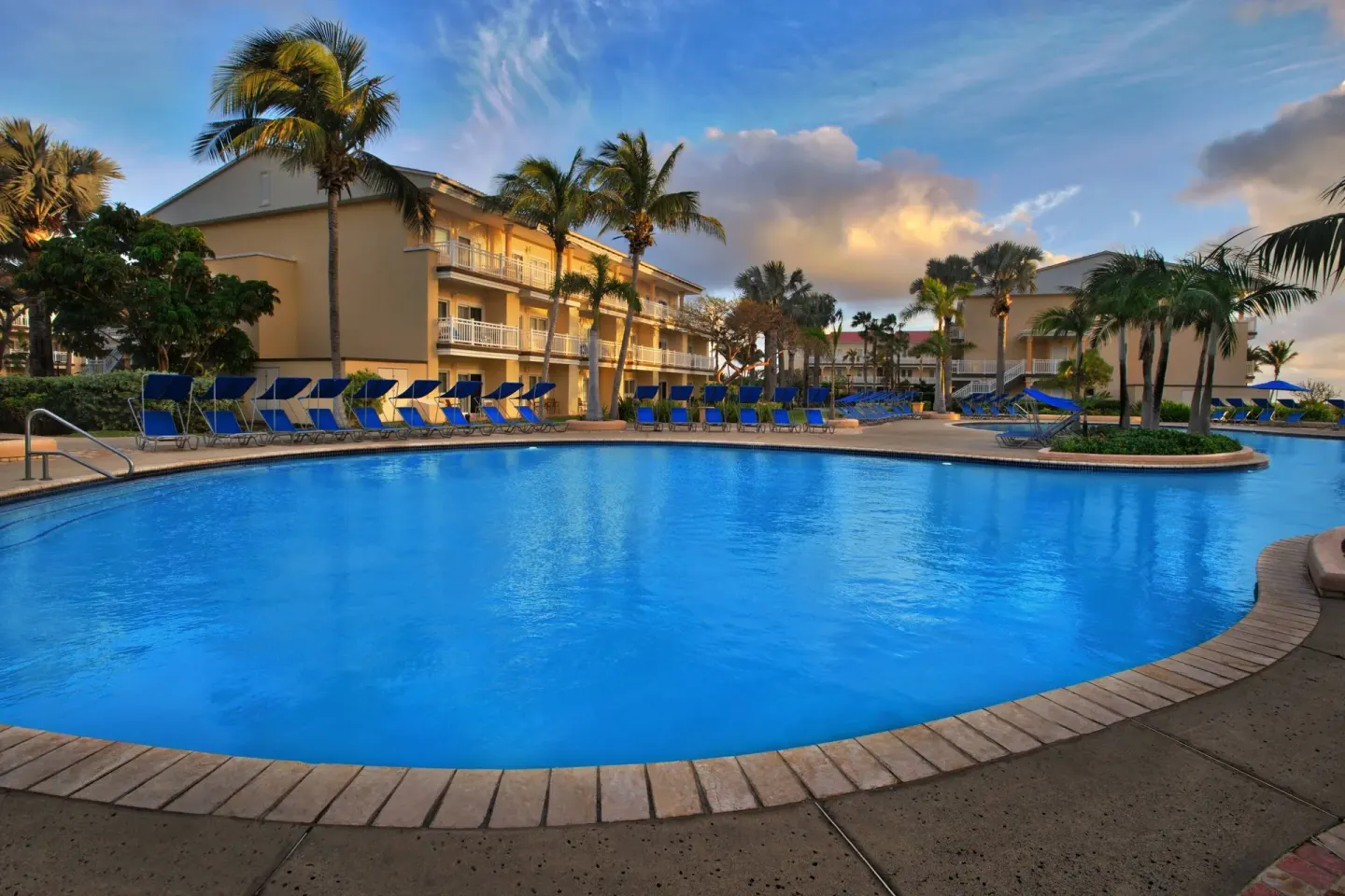 Outdoor pool with loungers and palm trees at Marriott's St. Kitts Beach Club.