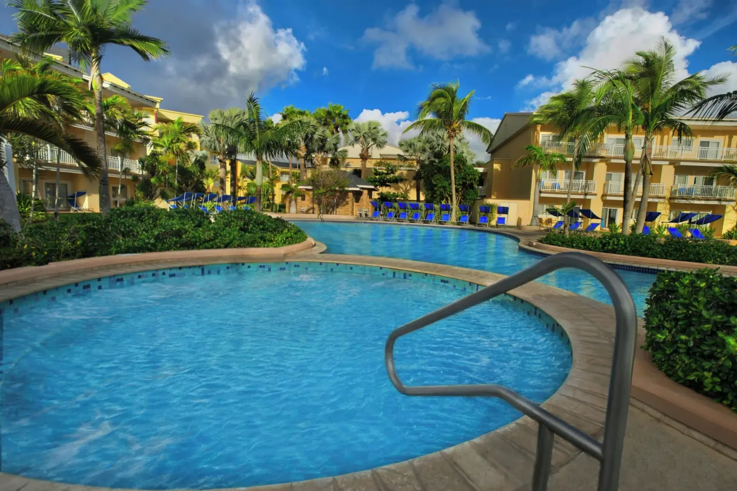 Pool steps, handrail and palm-lined deck at Marriott's St. Kitts Beach Club.