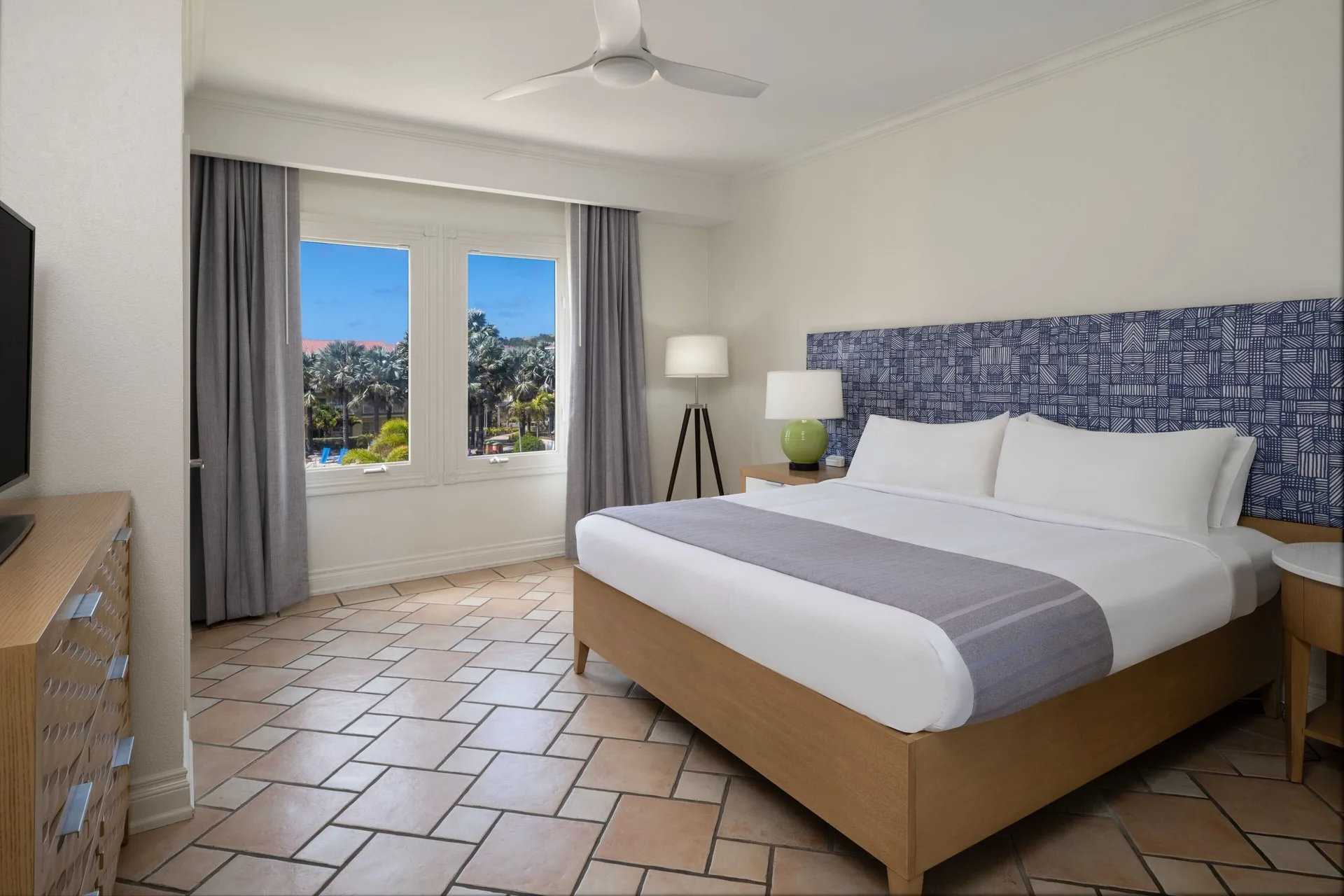 King bedroom in a three-bedroom villa at Marriott's St. Kitts Beach Club with windows and tiled floor.