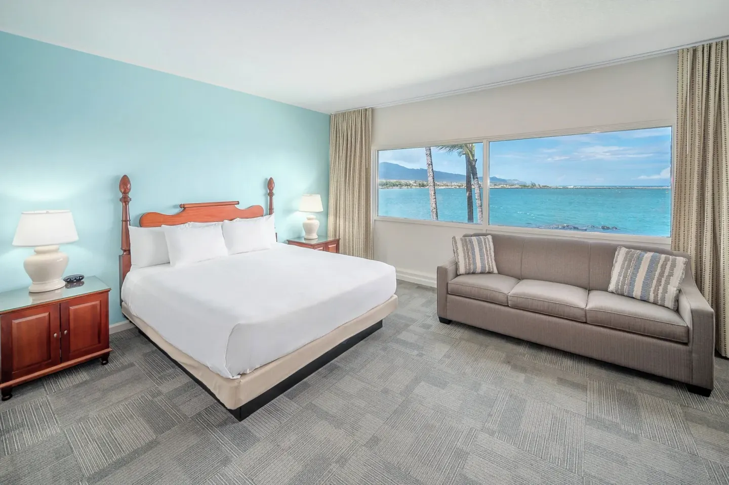 Oceanfront king bed guest room with sofa at Maui Beach Hotel.