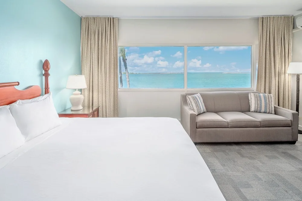 King bed guest room with sofa and ocean window at Maui Beach Hotel.