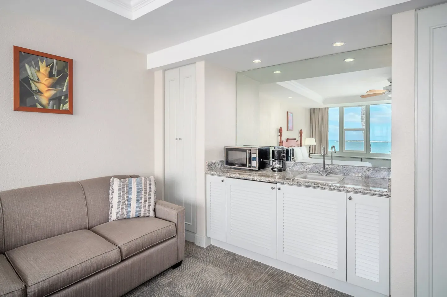 Suite sitting area with wet bar and ocean-view mirror at Maui Beach Hotel.