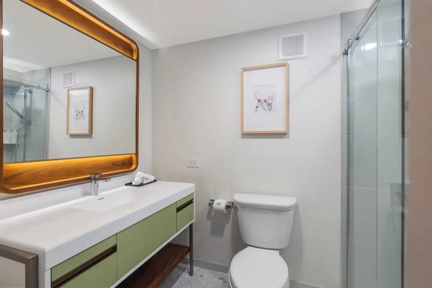 Modern bathroom with vanity, toilet, and glass shower at Maui Seaside Hotel.