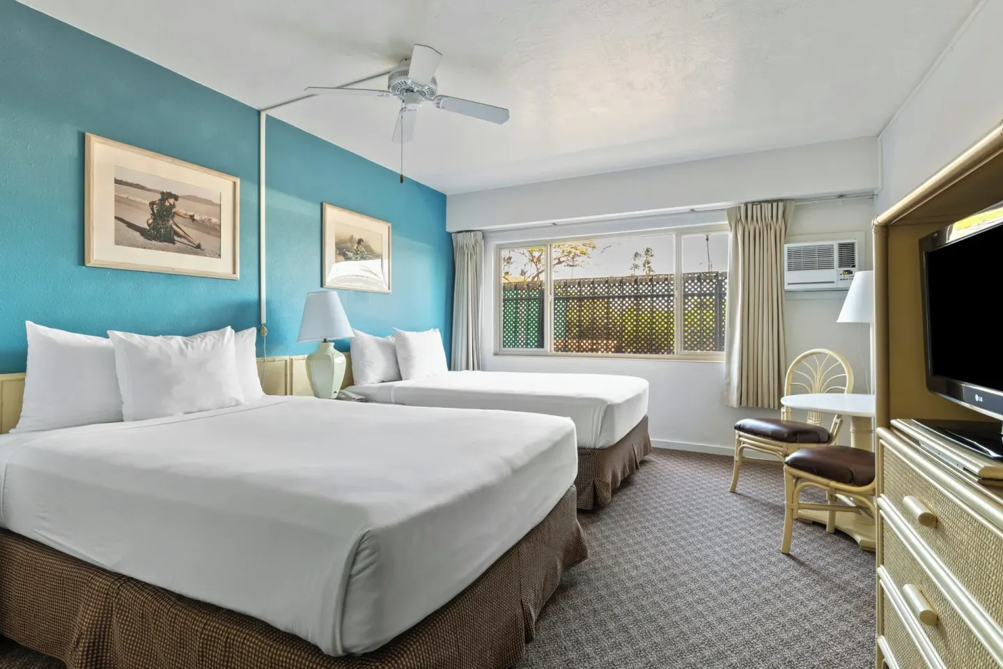 Standard Room with two beds, large window and TV dresser at Maui Seaside Hotel.