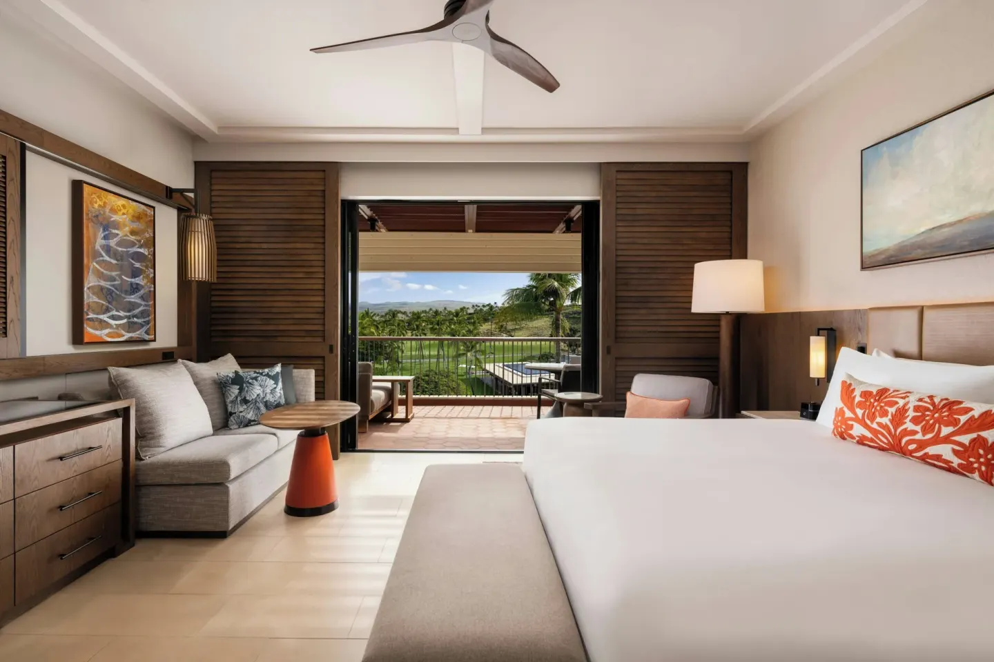 King bed room with sofa and golf-view balcony at Mauna Kea Beach Hotel.