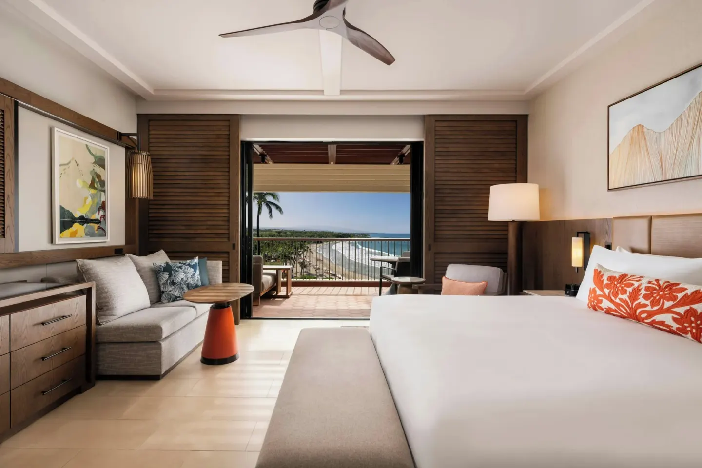 Renovated oceanfront king room with palm and shoreline view at Mauna Kea Beach Hotel.