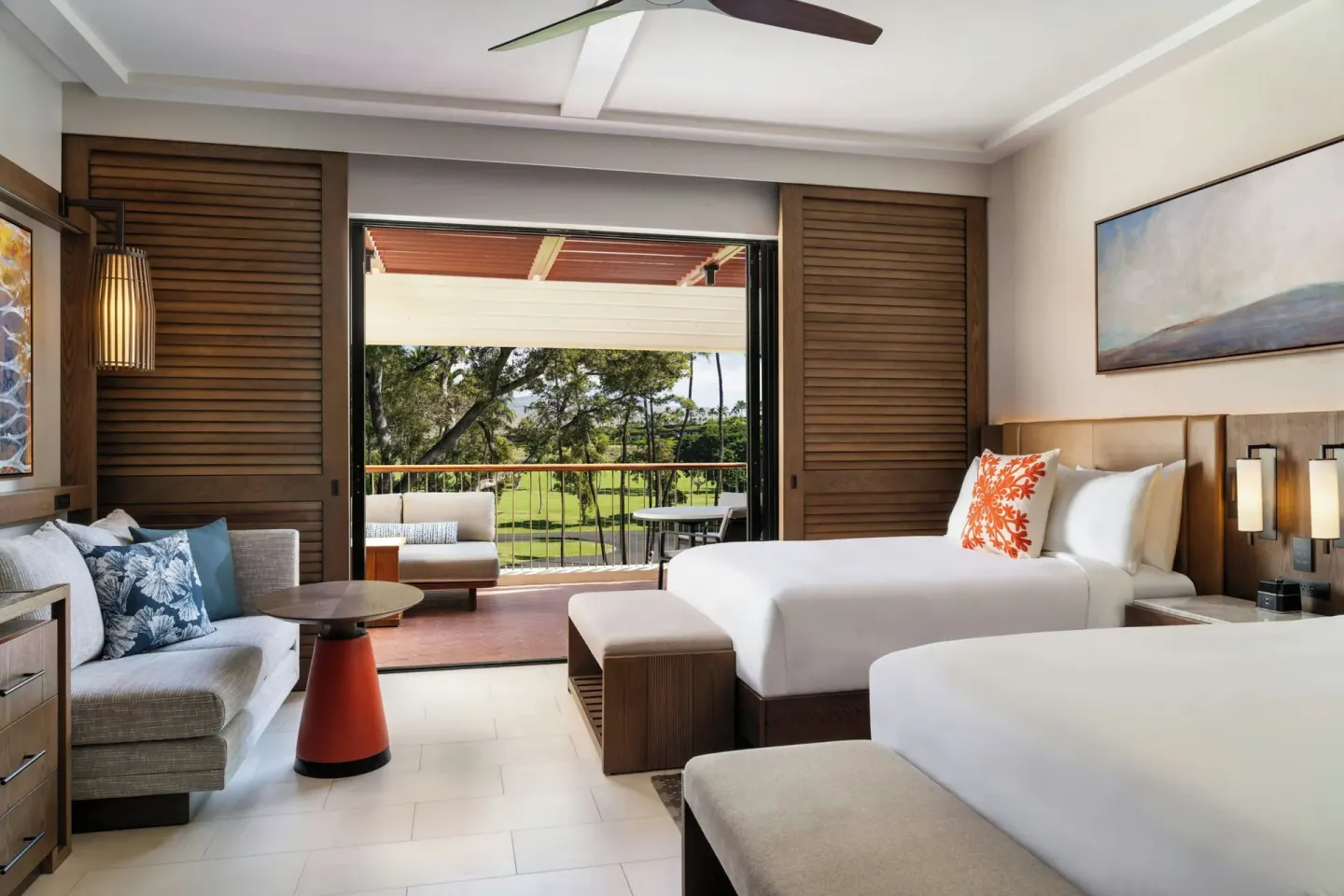 Two-bed golf-view tower room with balcony seating at Mauna Kea Beach Hotel.