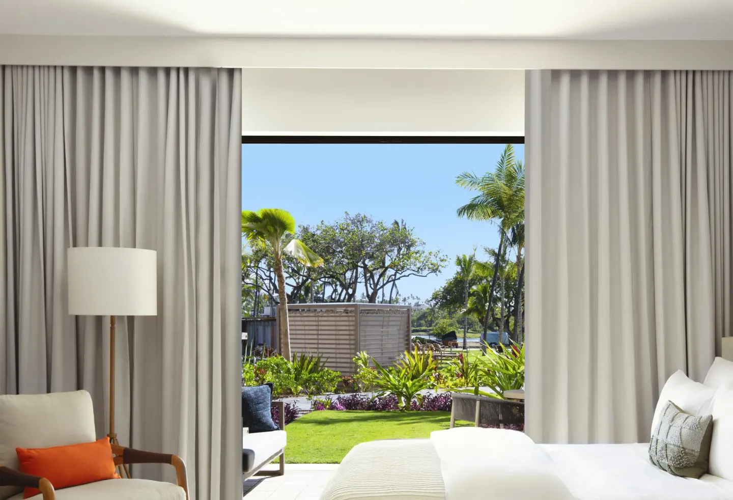 King guest room opening to a garden patio at Mauna Lani.