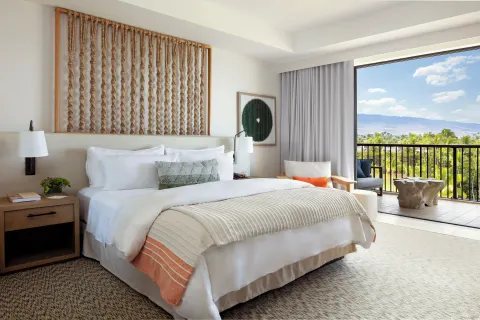 King bed guest room with balcony and mountain views at Mauna Lani.