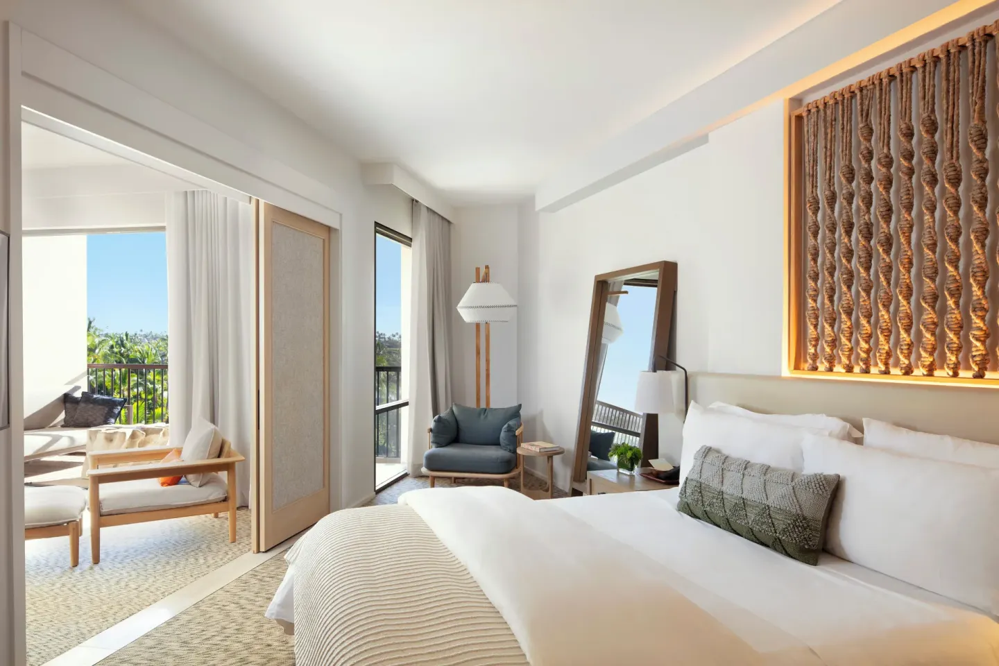 King bed guest room with sitting area and balcony at Mauna Lani.