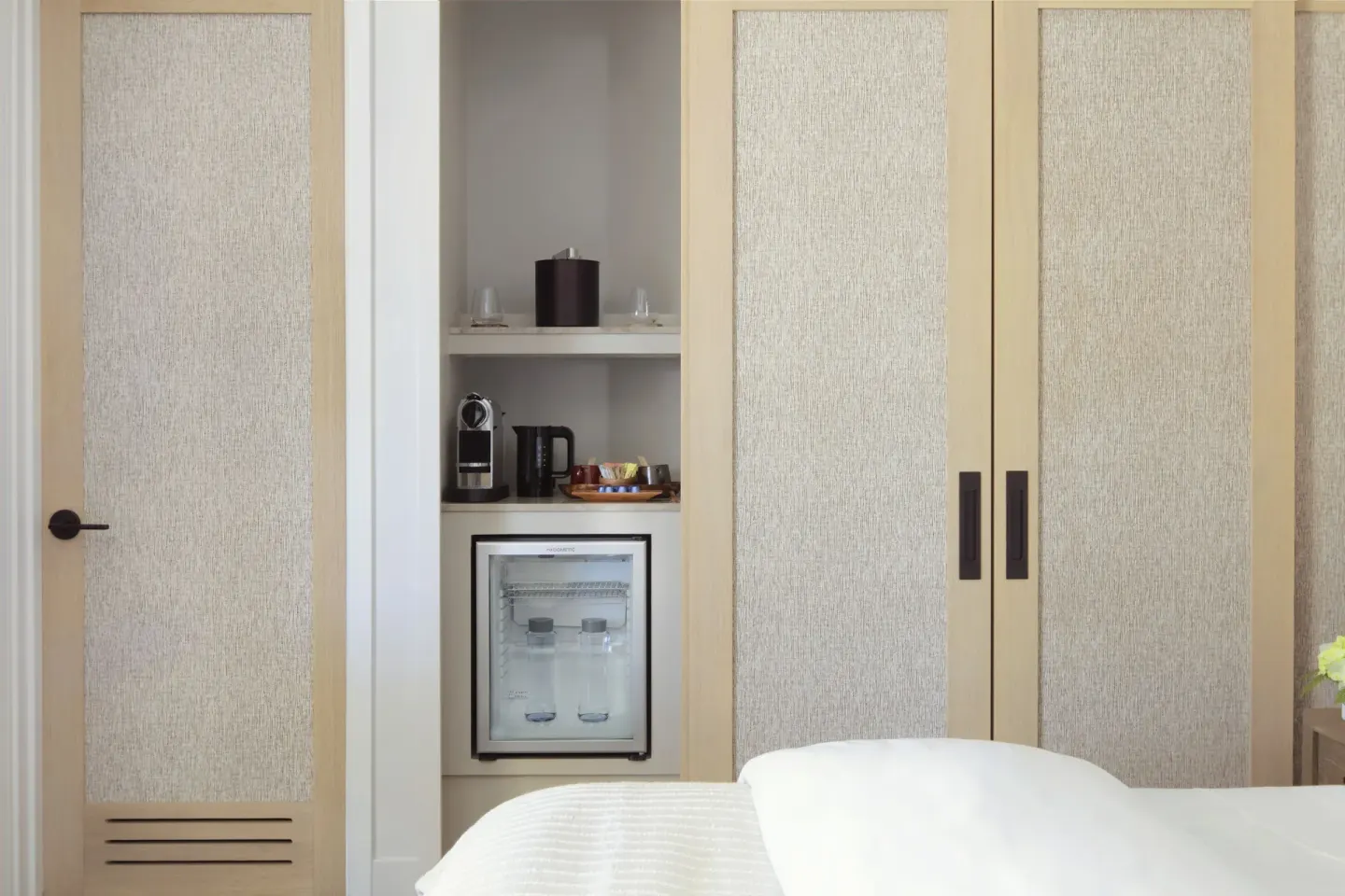 Guest room refreshment cabinet with mini fridge and coffee setup at Mauna Lani.