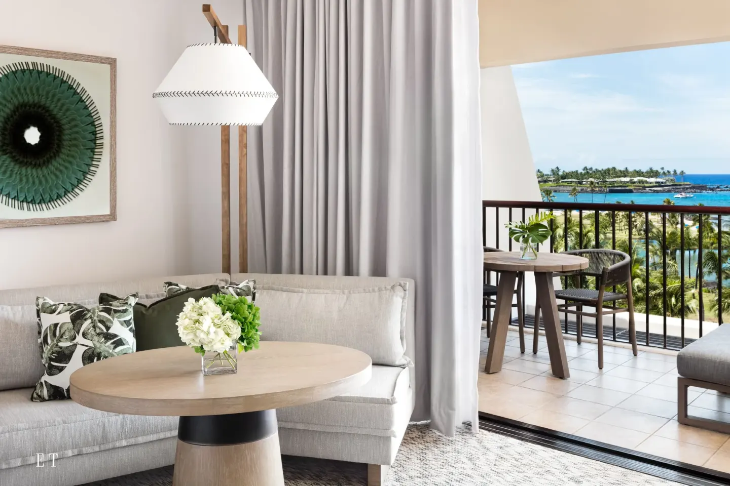 Guest room sitting area with balcony and ocean view at Mauna Lani.