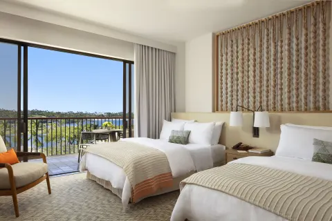 Two-bed guest room with balcony and water view at Mauna Lani.