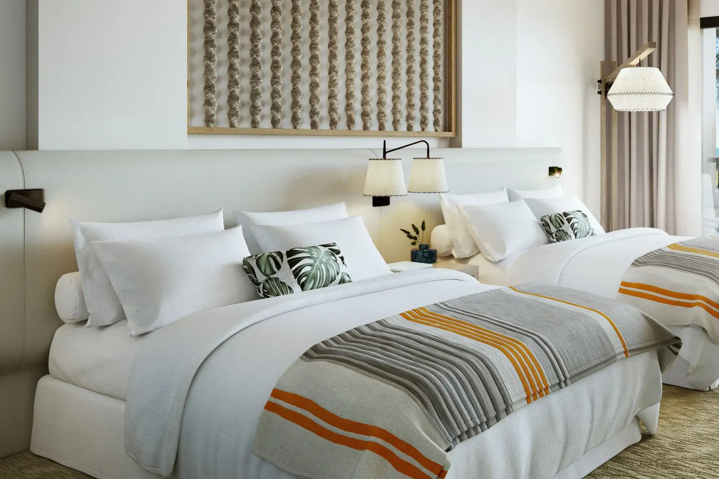 Guest room with two beds, white linens, and patterned pillows at Mauna Lani.