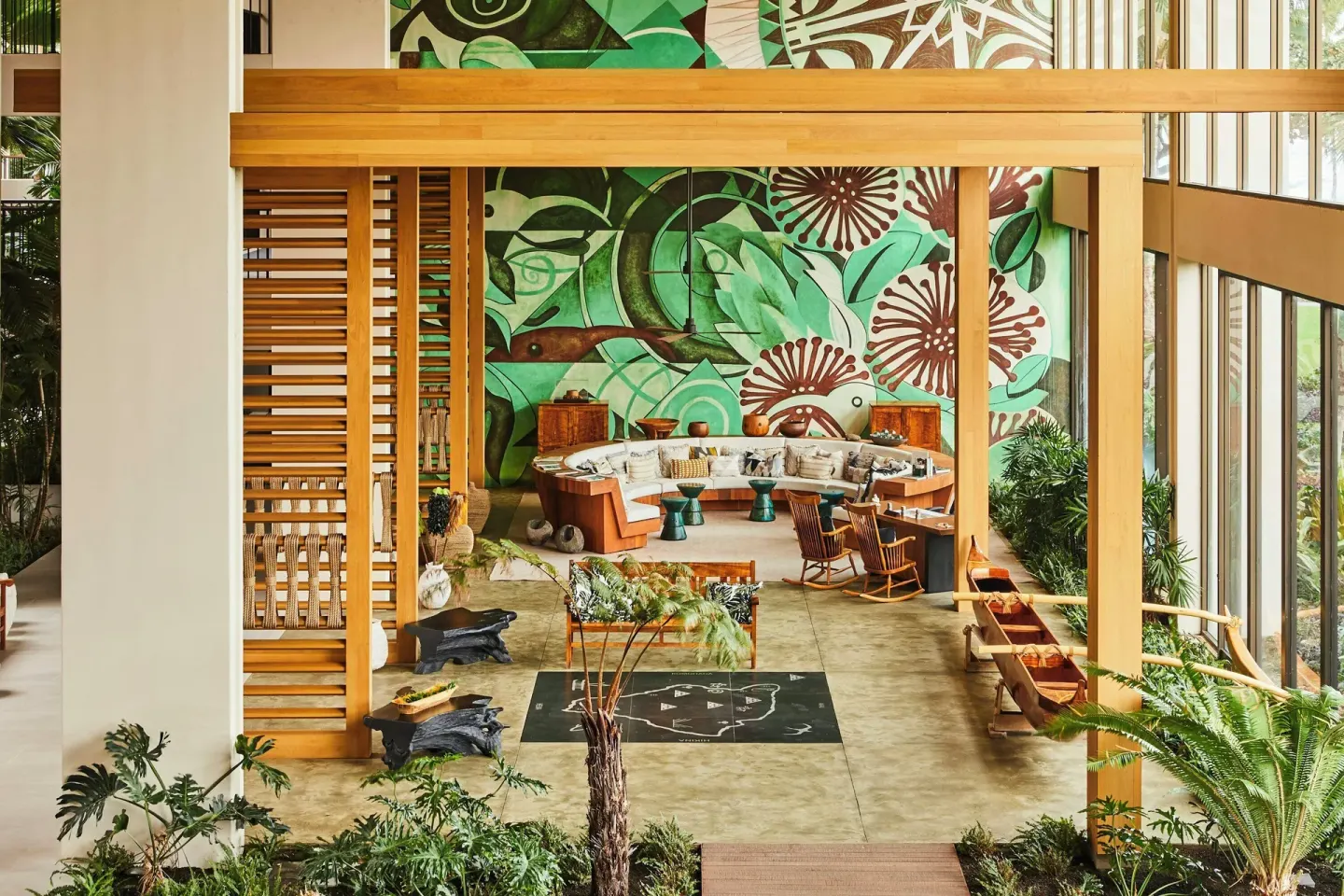 Lobby seating area with tropical mural and wood screens at Mauna Lani.