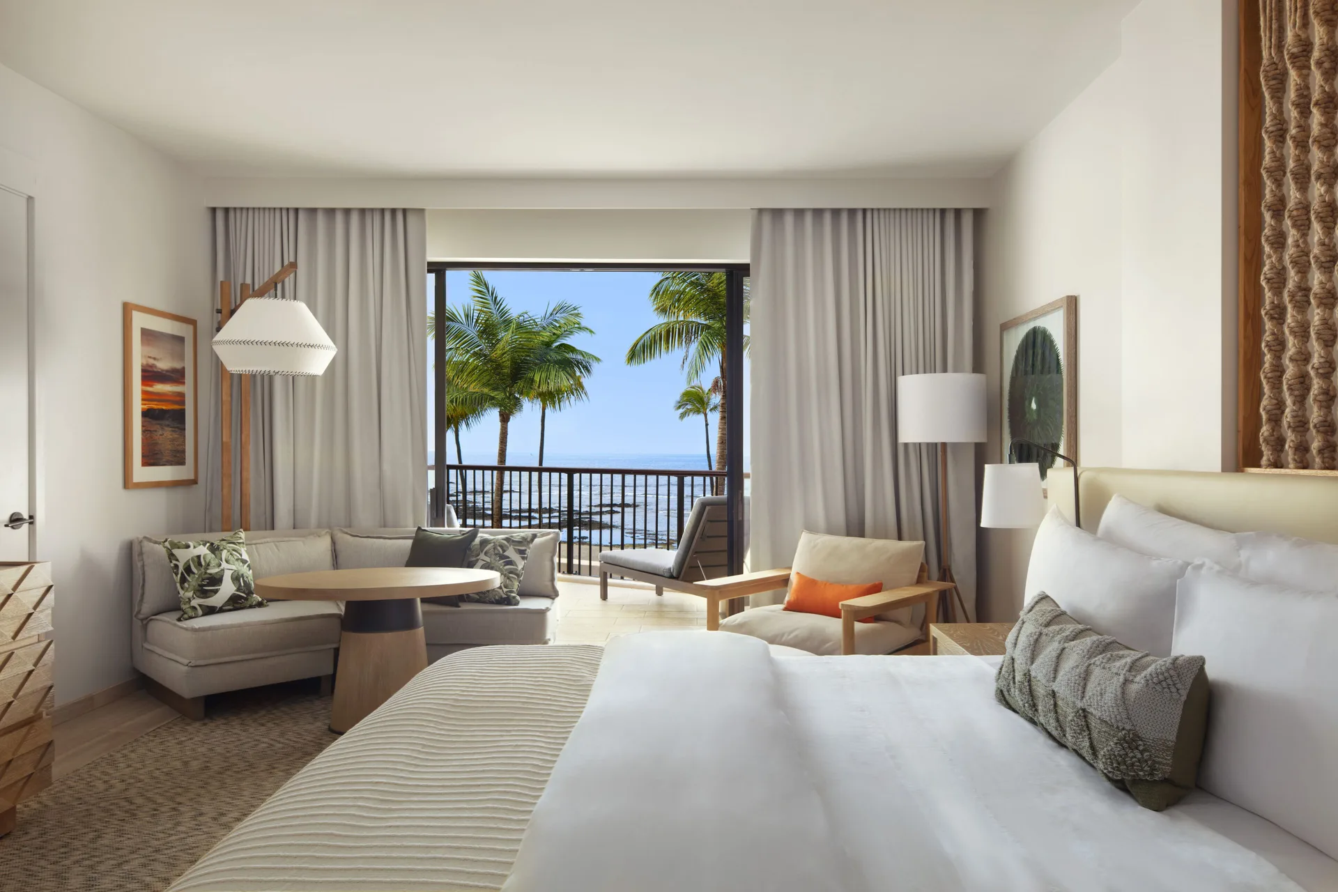 King guest room with sofa seating and an ocean-view balcony at Mauna Lani.