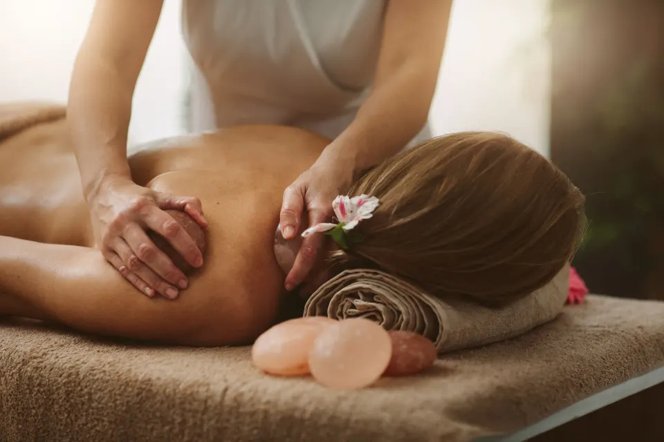 Massage treatment with towels, stones, and a flower at Mauna Lani.