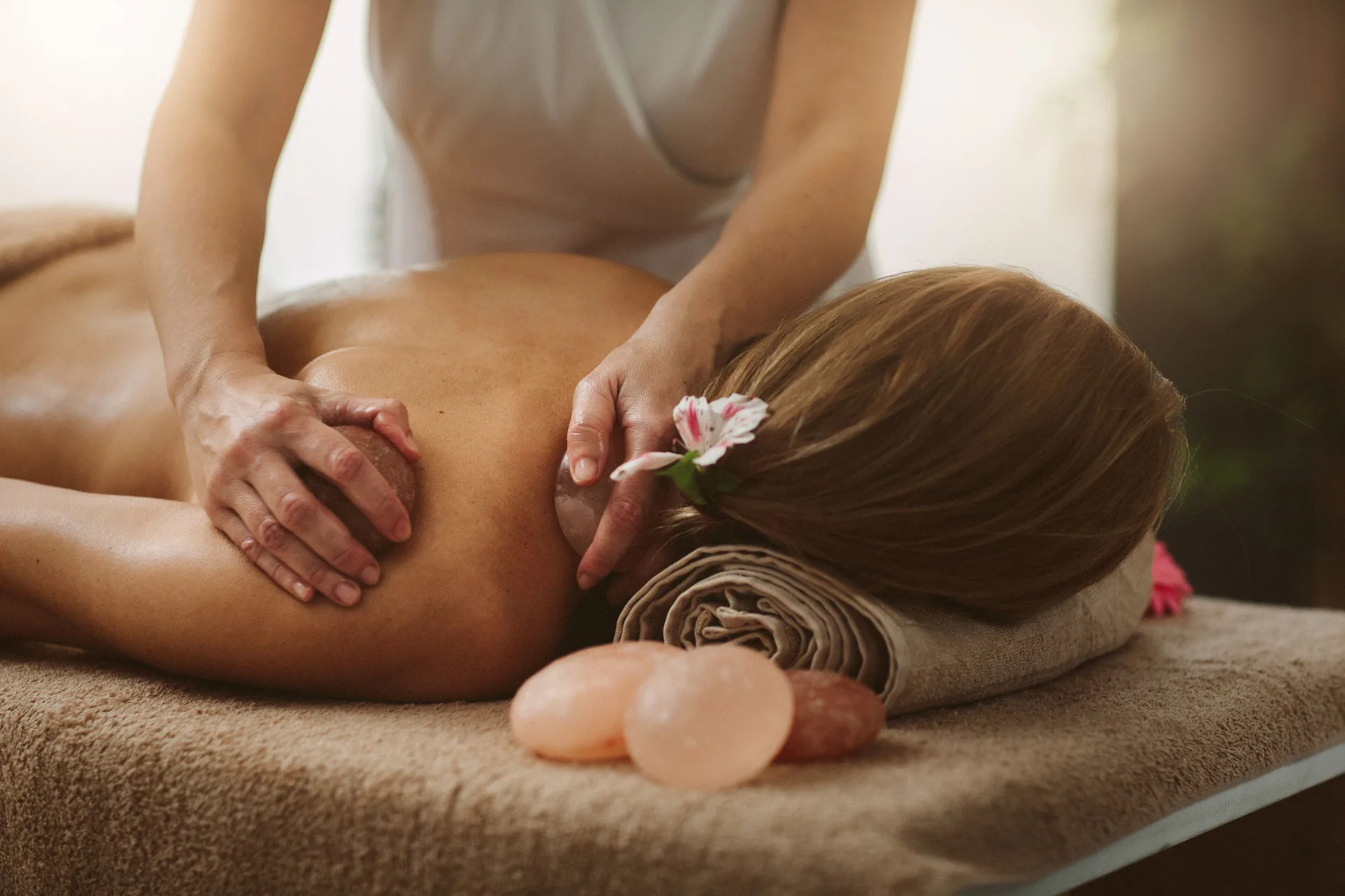 Massage treatment with towels, stones, and a flower at Mauna Lani.