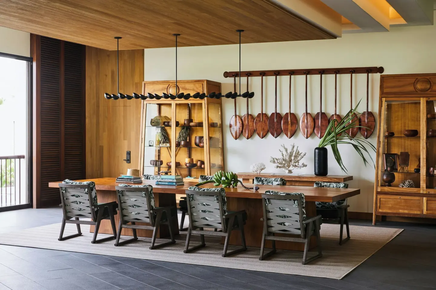 Wood meeting table with display cabinets and canoe paddles at Mauna Lani.