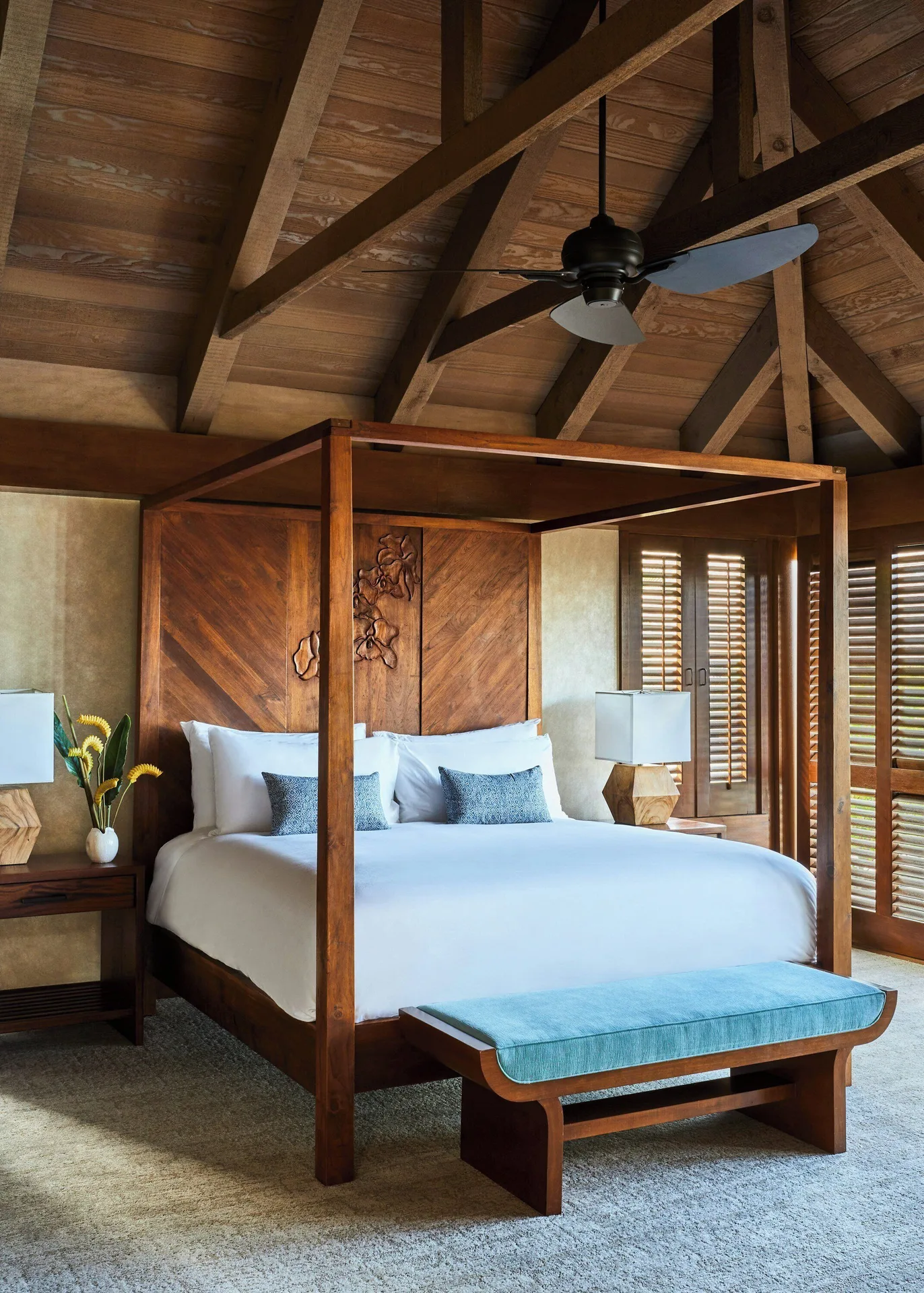 Oceanfront two-bedroom villa bedroom with canopy bed and wood ceiling at Mauna Lani.