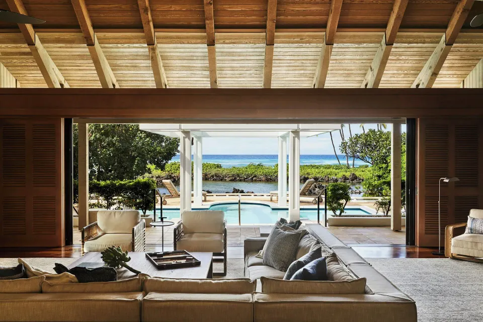 Oceanfront two-bedroom villa lounge opening to a private pool and ocean view at Mauna Lani.