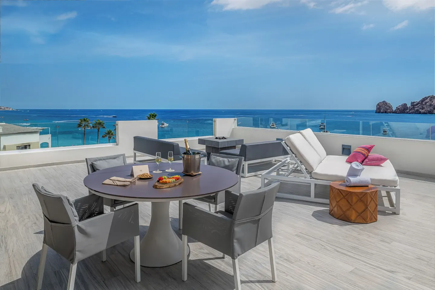 Beyond ME+ Suite terrace at ME Cabo with dining table, loungers, and ocean view.