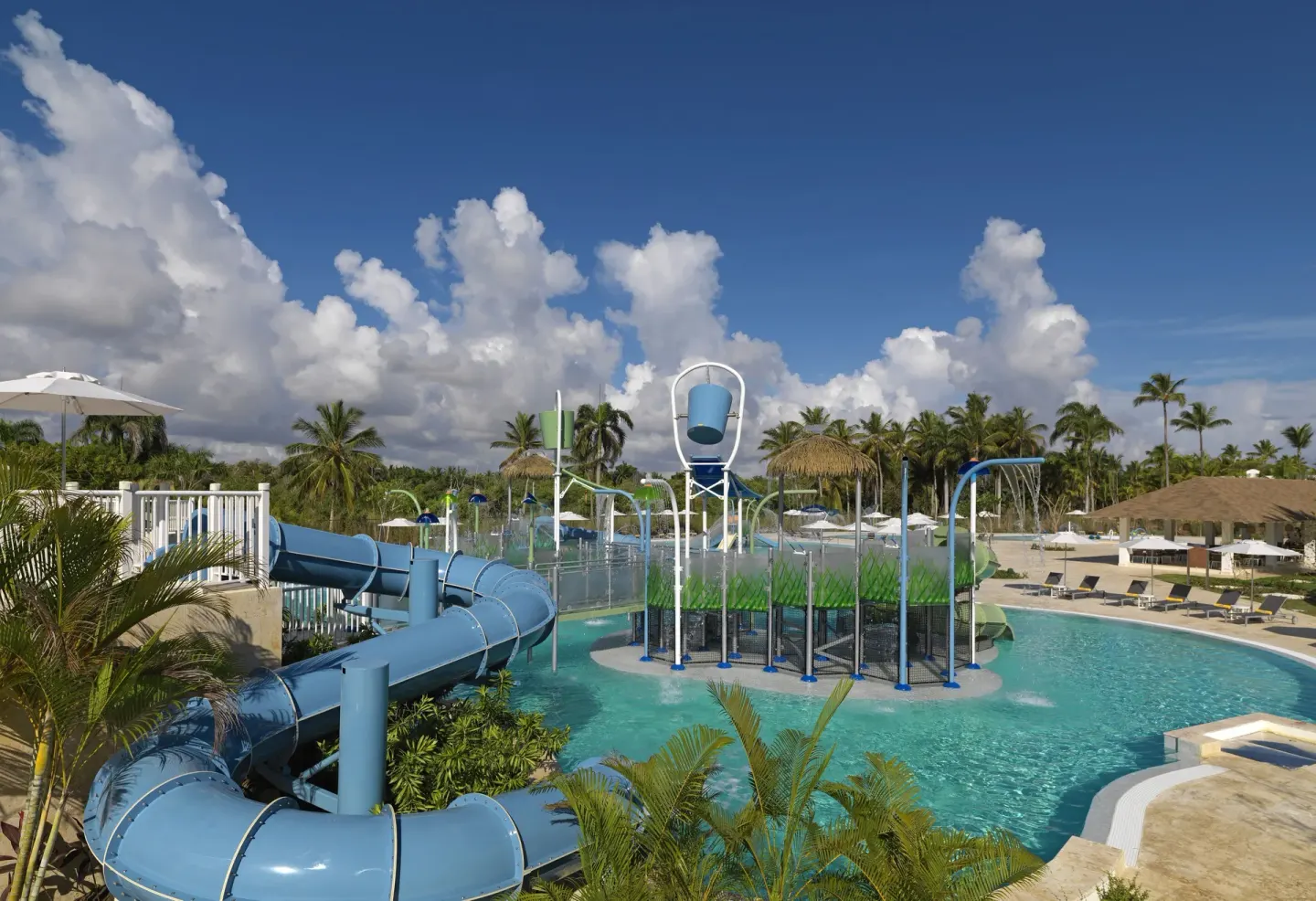 Aqua park pool with a winding slide and splash bucket at Melia Caribe Beach Resort.