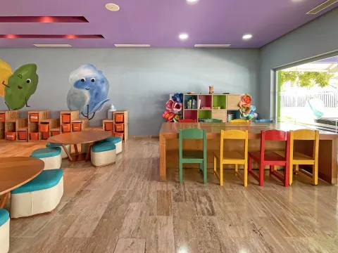 Children's activity room with craft tables and colorful chairs at Melia Caribe Beach Resort.