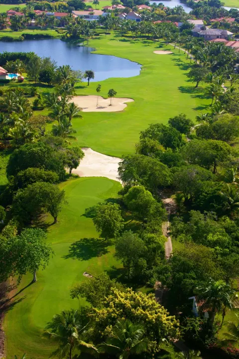 Aerial view of a golf course and lagoon near Melia Caribe Beach Resort.