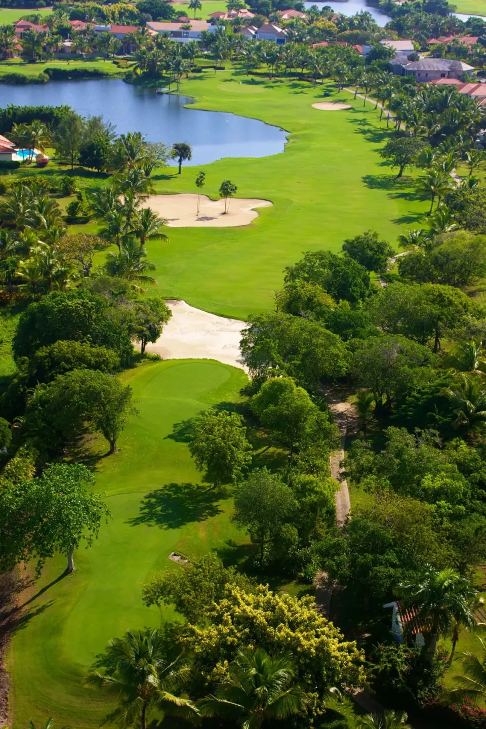 Aerial view of a golf course and lagoon near Melia Caribe Beach Resort.