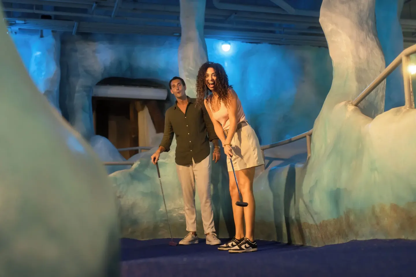 Couple playing indoor mini golf at Melia Caribe Beach Resort.