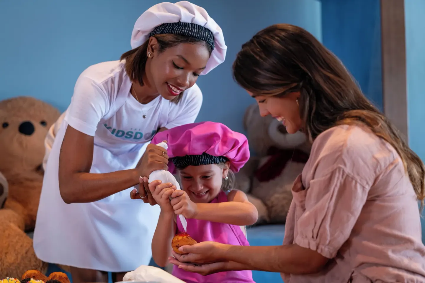 Child decorating a pastry during a kids cooking activity at Melia Caribe Beach Resort.