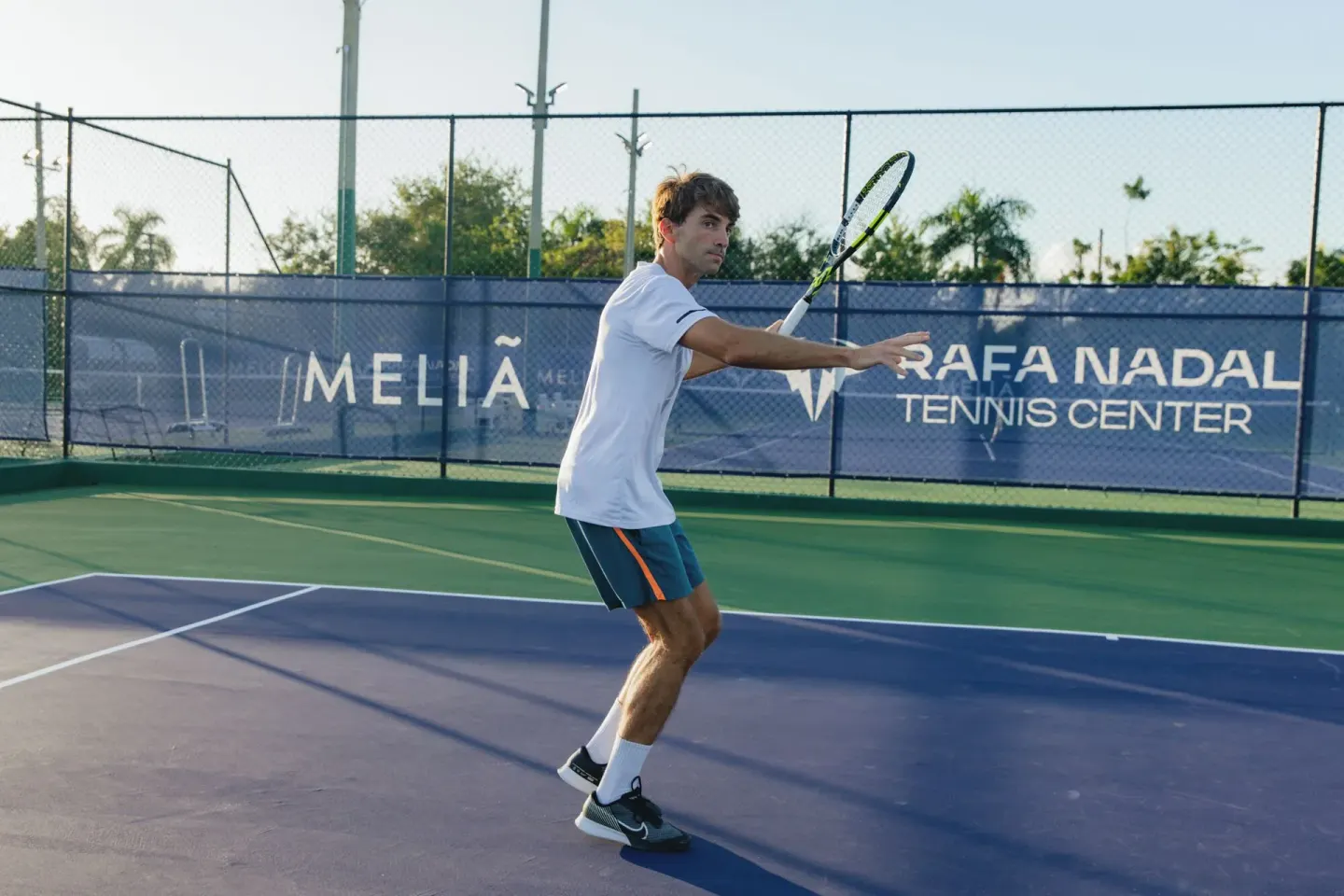 Tennis player on an outdoor court at Melia Caribe Beach Resort.