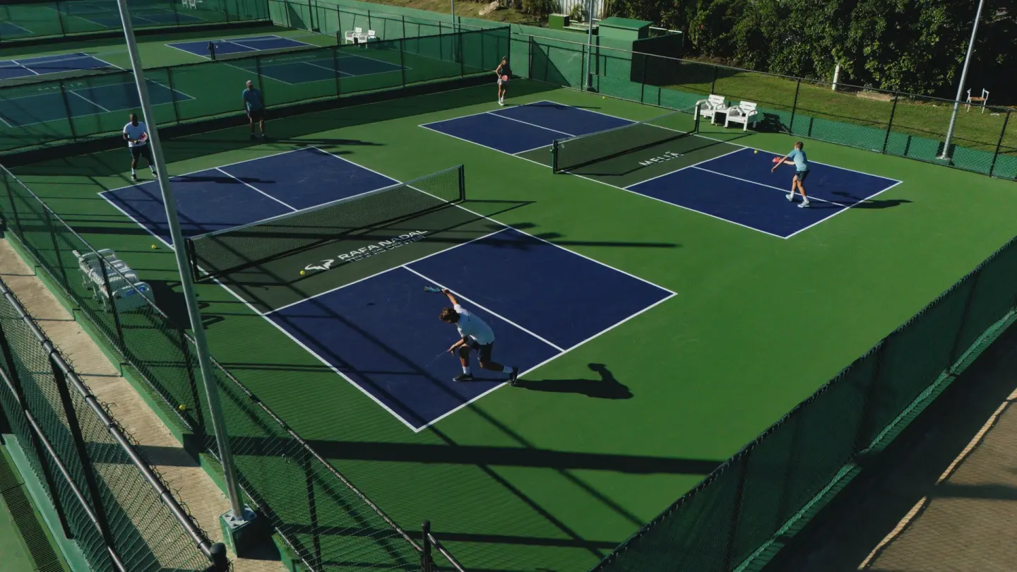 Aerial view of multiple outdoor tennis courts at Melia Caribe Beach Resort.